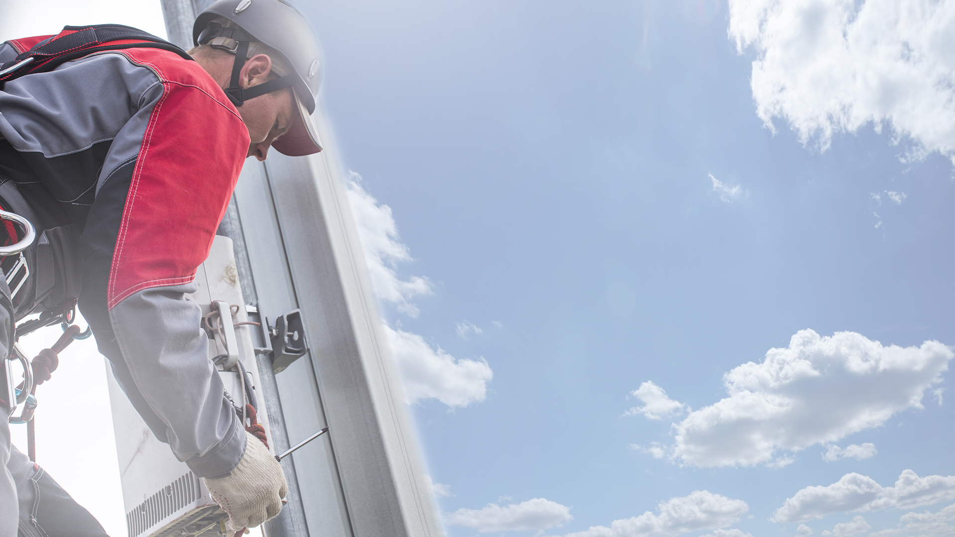 repairman on a telecommunications tower. repairman on a telecomm